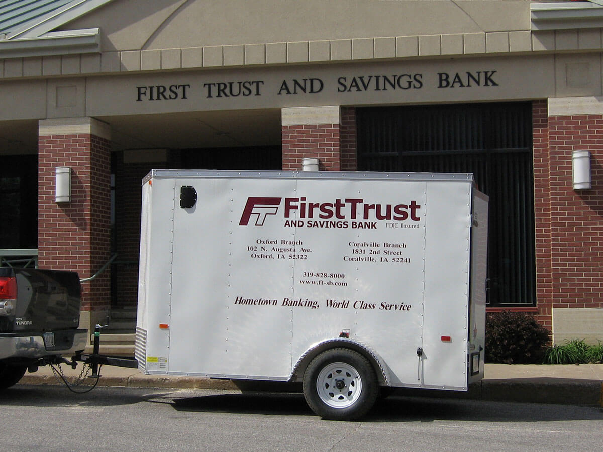 FTSB Party Trailer attached to a truck sitting in front of the bank.